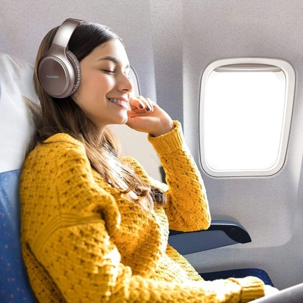 A person wearing headphones on flight