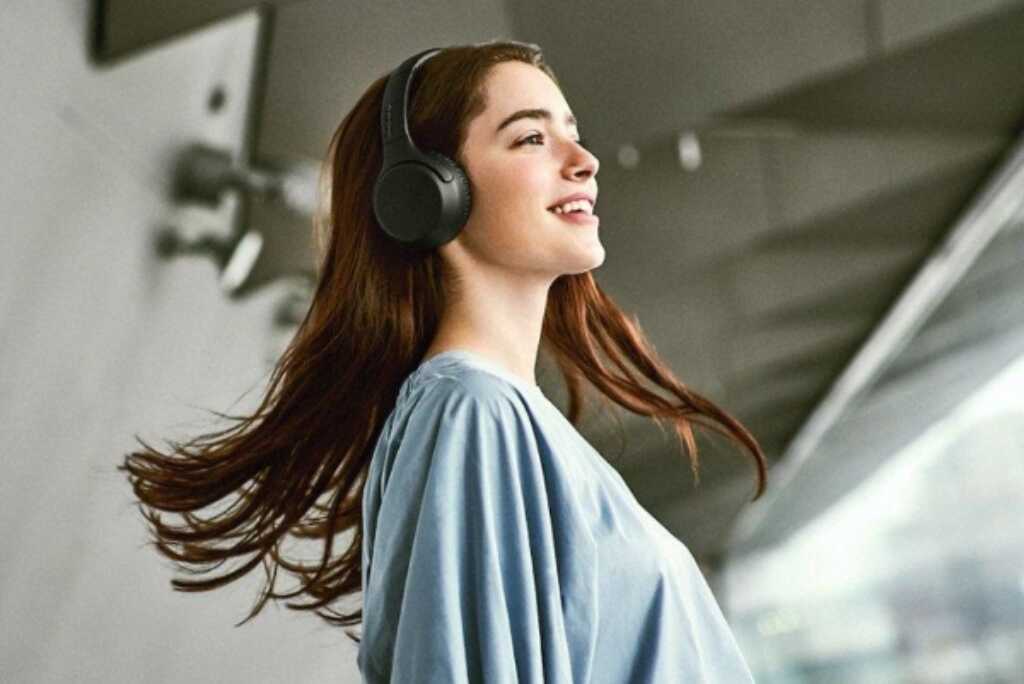 A person is enjoying music with a pair of headphones